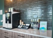 Thumbnail 11 of 53 - a coffee machine on a counter in front of a brick wall